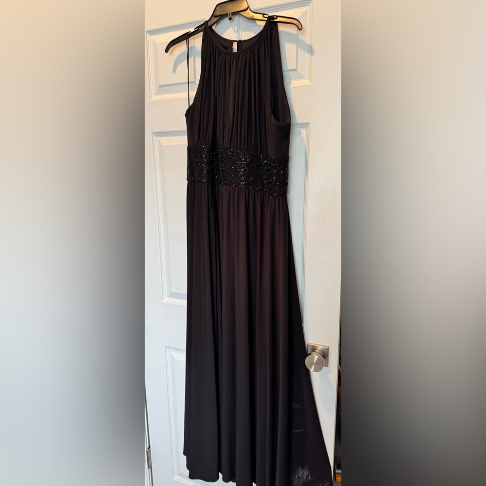 JS black gown, with black sequins at bodice. Split modestly in front of